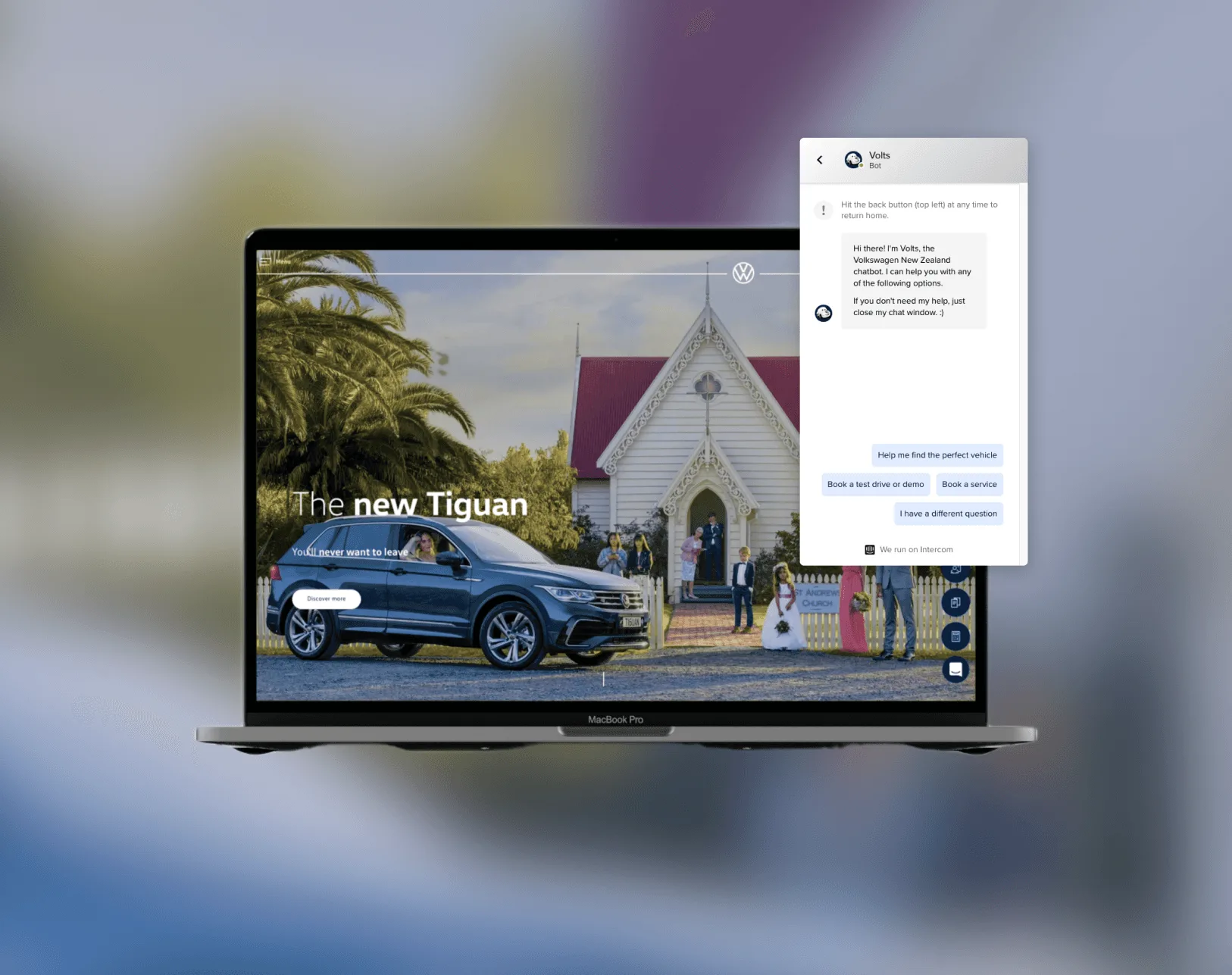 Volkswagen NZ website on a laptop with the Volts chatbot open, offering options to find a vehicle, book a test drive or book a service