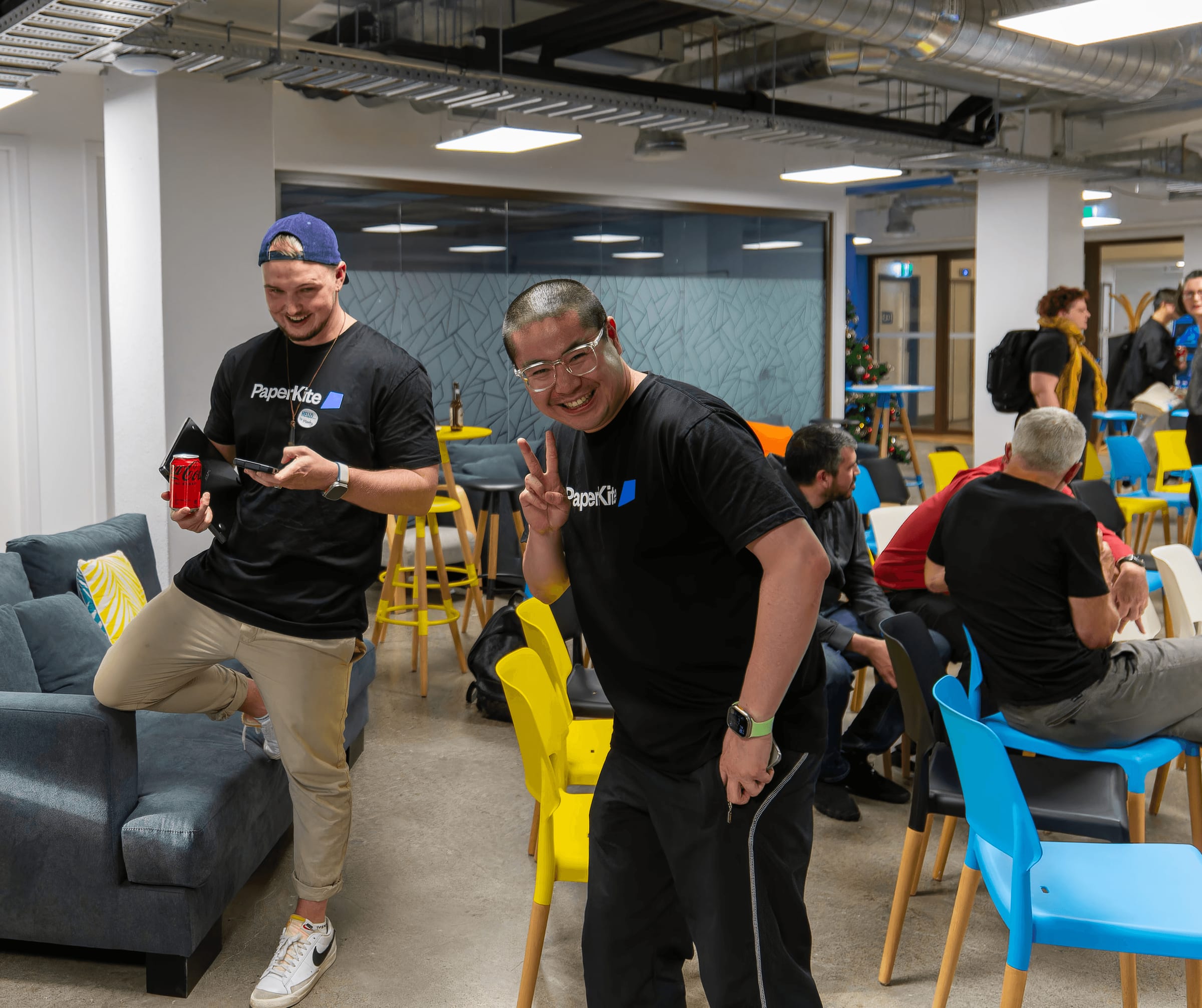 PaperKiters engaging in lively conversations and sharing laughs during a company-hosted event in a welcoming, collaborative space